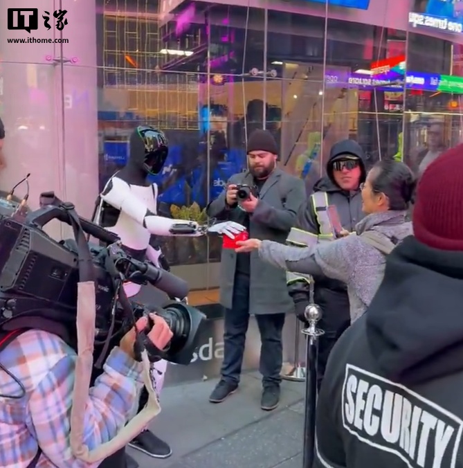 特斯拉人形机器人 Optimus 现身纽约时代广场，向路人派发糖果